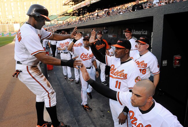 BALTIMORE - JUNE 10:  Corey Patterson #6 of the Baltimore Orioles is congratulated by Nick Markakis #21 and Interim Manager Juan Samuel after scoring in the first inning against the New York Yankees at Camden Yards on June 10, 2010 in Baltimore, Maryland.  (Photo by Greg Fiume/Getty Images)