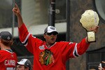 CHICAGO - JUNE 11: Dustin Byfuglien #33 waves the crowd during the Chicago Blackhawks Stanley Cup victory parade and rally on June 11, 2010 in Chicago, Illinois. (Photo by Jonathan Daniel/Getty Images)