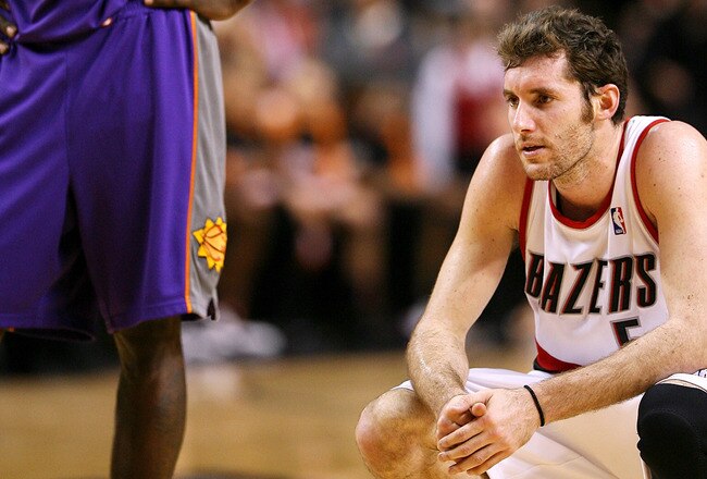 PORTLAND, OR - APRIL 29:  Rudy Fernandez #5 of the Portland Trail Blazers crouches near the end of the game as Jason Richardson #23 of the Phoenix Suns looks on during Game Six of the Western Conference Quarterfinals of the NBA Playoffs on April 29, 2010 at the Rose Garden in Portland, Oregon. The Suns defeated the Blazers  99-90. NOTE TO USER: User expressly acknowledges and agrees that, by downloading and or using this Photograph, user is consenting to the terms and conditions of the Getty Images License Agreement. (Photo by Otto Greule Jr/Getty Images)