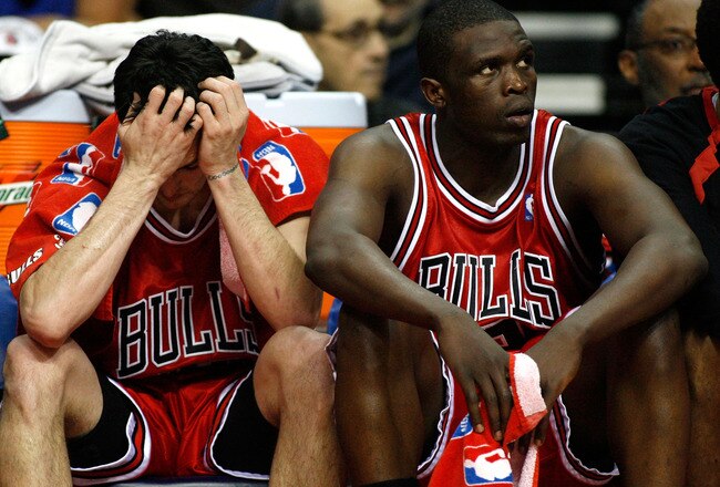 AUBURN HILLS, MI - MAY 7:  Kirk Hinrich #12 and Luol Deng #9 of the Chicago Bulls look on from the bench during the fourth quarter against the Detroit Pistons in Game Two of the Eastern Conference Semifinals during the 2007 NBA Playoffs on May 7, 2007 at the Palace of Auburn Hills in Auburn Hills, Michigan. The Pistons defeated the Bulls 108-87 and take a 2-0 lead in the series.  NOTE TO USER: User expressly acknowledges and agrees that, by downloading and or using this photograph, User is consenting to the terms and conditions of the Getty Images License Agreement.  (Photo by Gregory Shamus/Getty Images)