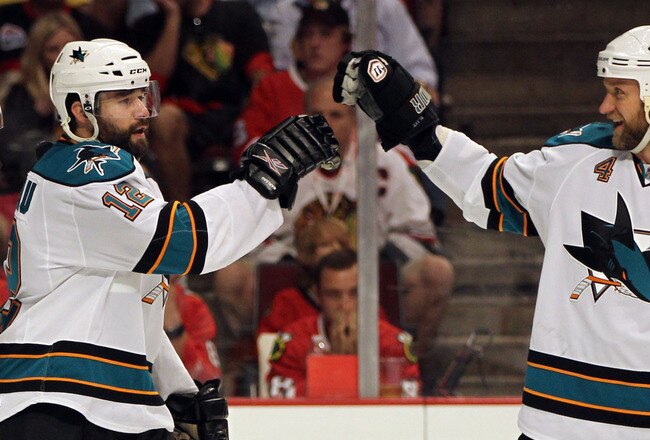 CHICAGO - MAY 23:  (L) Patrick Marleau #12 of the San Jose Sharks celebrates his second period goal with teammate Rob Blake #4 while taking on the Chicago Blackhawks in Game Four of the Western Conference Finals during the 2010 NHL Stanley Cup Playoffs at the United Center on May 23, 2010 in Chicago, Illinois.  (Photo by Jamie Squire/Getty Images)