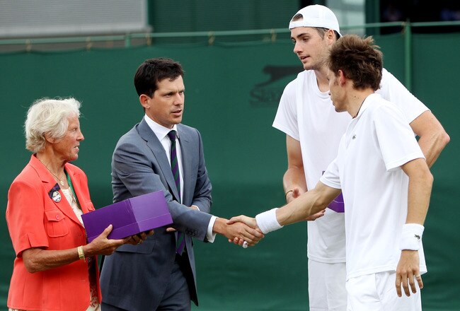 LONDON, ENGLAND - JUNE 24:  John Isner of USA after (2ndR) is greeted by Tim Henman (L) after winning on the third day of his first round match against Nicolas Mahut of France on Day Four of the Wimbledon Lawn Tennis Championships at the All England Lawn Tennis and Croquet Club on June 24, 2010 in London, England. The match is the longest in Grand Slam history.  (Photo by Alastair Grant-Pool/Getty Images)