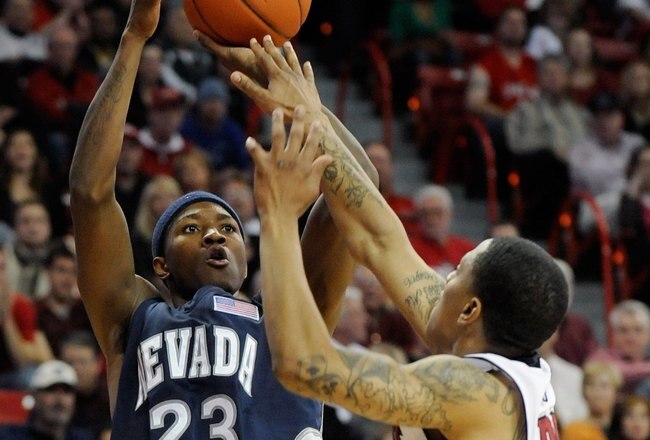 LAS VEGAS - NOVEMBER 18:  Armon Johnson #23 of the Nevada Wolf Pack shoots over Tre'Von Willis #33 of the UNLV Rebels during their game at the Thomas & Mack Center on November 18, 2009 in Las Vegas, Nevada. UNLV won 88-75.  (Photo by Ethan Miller/Getty Images)