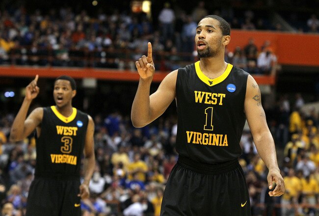 SYRACUSE, NY - MARCH 27:  Da'Sean Butler #1 and Devin Ebanks #3 of the West Virginia Mountaineers react in the second half against the Kentucky Wildcats during the east regional final of the 2010 NCAA men's basketball tournament at the Carrier Dome on March 27, 2010 in Syracuse, New York.  (Photo by Jim McIsaac/Getty Images)