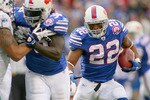 ORCHARD PARK, NY - NOVEMBER 29:  Fred Jackson #22 of the Buffalo Bills runs for his first  touchdown against  the Miami Dolphins behind a block by Corey McIntyre #38 at Ralph Wilson Stadium on November 29, 2009 in Orchard Park, New York. Buffalo won 31-14.  (Photo by Rick Stewart/Getty Images)