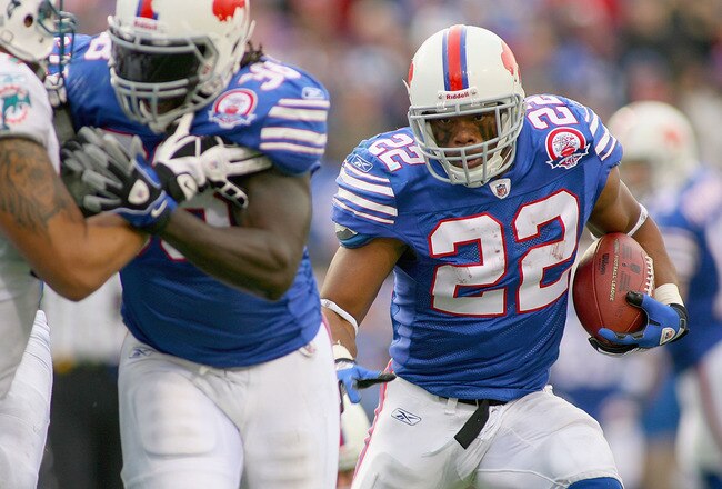 ORCHARD PARK, NY - NOVEMBER 29:  Fred Jackson #22 of the Buffalo Bills runs for his first  touchdown against  the Miami Dolphins behind a block by Corey McIntyre #38 at Ralph Wilson Stadium on November 29, 2009 in Orchard Park, New York. Buffalo won 31-14.  (Photo by Rick Stewart/Getty Images)