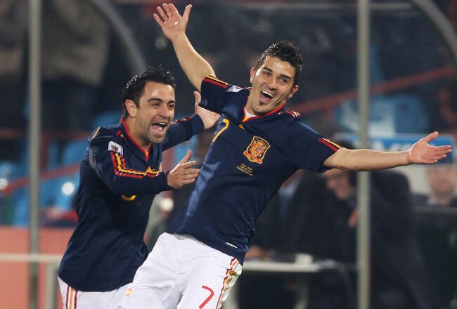 PRETORIA, SOUTH AFRICA - JUNE 25:  David Villa of Spain celebrates scoring the opening goal with team mate Xavi Hernandez during the 2010 FIFA World Cup South Africa Group H match between Chile and Spain at Loftus Versfeld Stadium on June 25, 2010 in Tshwane/Pretoria, South Africa.  (Photo by Phil Cole/Getty Images)