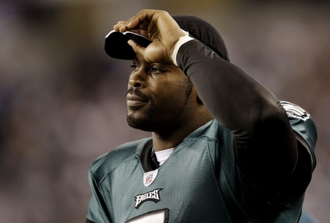 ARLINGTON, TX - JANUARY 9:  Michael Vick #7 of the Philadelphia Eagles looks on from the sideline in the second quarter against the Dallas Cowboys during the 2010 NFC wild-card playoff game at Cowboys Stadium on January 9, 2010 in Arlington, Texas. (Photo by Jamie Squire/Getty Images)