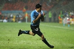 PORT ELIZABETH, SOUTH AFRICA - JUNE 26:  Luis Suarez of Uruguay celebrates scoring his second goal in the driving rain during the 2010 FIFA World Cup South Africa Round of Sixteen match between Uruguay and South Korea at Nelson Mandela Bay Stadium on June 26, 2010 in Nelson Mandela Bay/Port Elizabeth, South Africa.  (Photo by Doug Pensinger/Getty Images)