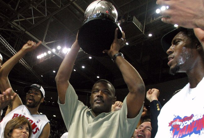 AUBURN HILLS, MI - JUNE 1:  (L-R) Chauncey Billups #1, Rasheed Wallace #30, President of Basketball Operations Joe Dumars (holding trophy) and Ben Wallace #3 of the Detroit Pistons celebrate their win over the Indiana Pacers in Game six of the Eastern Conference Finals during the 2004 NBA Playoffs at The Palace of Auburn Hills on June 1, 2004 in Auburn Hills, Michigan.  The Pistons defeated the Pacers 69-65 and won the 2004 Eastern Conference Championship.  NOTE TO USER: User expressly acknowledges and agrees that, by downloading and/or using this Photograph, user is consenting to the terms and conditions of the Getty Images License Agreement. (Photo by Tom Pidgeon/Getty Images)