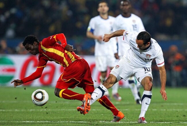 RUSTENBURG, SOUTH AFRICA - JUNE 26: Landon Donovan of the United States tackles Anthony Annan of Ghana during the 2010 FIFA World Cup South Africa Round of Sixteen match between USA and Ghana at Royal Bafokeng Stadium on June 26, 2010 in Rustenburg, South Africa.  (Photo by Ian Walton/Getty Images)