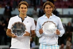 MADRID, SPAIN - MAY 16:  Mens finalist Rafael Nadal and  Roger Federer of Switzerland hold aloft their trophies after the mens final match during the Mutua Madrilena Madrid Open tennis tournament at the Caja Magica on May 16, 2010 in Madrid, Spain.  (Photo by Clive Brunskill/Getty Images)