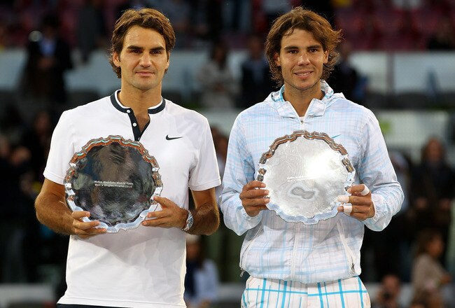 MADRID, SPAIN - MAY 16:  Mens finalist Rafael Nadal and  Roger Federer of Switzerland hold aloft their trophies after the mens final match during the Mutua Madrilena Madrid Open tennis tournament at the Caja Magica on May 16, 2010 in Madrid, Spain.  (Photo by Clive Brunskill/Getty Images)