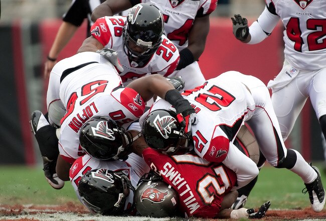 TAMPA, FL - JANUARY 03:  Running back Carnell Williams #24 of the Tampa Bay Buccaneers is tackled against the Atlanta Falcons during the game at Raymond James Stadium on January 3, 2010 in Tampa, Florida.  (Photo by J. Meric/Getty Images)