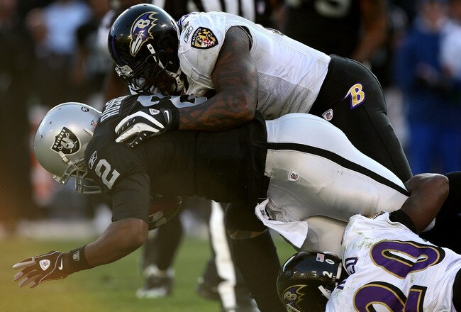 OAKLAND, CA - JANUARY 3: Terrell Suggs #55 of the Baltimore Ravens tackles JaMarcus Russell #2 of the Oakland Raiders during an NFL game at Oakland-Alameda County Coliseum on January 3, 2010 in Oakland, California. (Photo by Jed Jacobsohn/Getty Images)