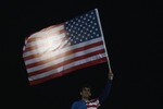 RUSTENBURG, SOUTH AFRICA - JUNE 26:  A USA fan flies the national flag in front of a full moon prior to the 2010 FIFA World Cup South Africa Round of Sixteen match between USA and Ghana at Royal Bafokeng Stadium on June 26, 2010 in Rustenburg, South Africa.  (Photo by Ian Walton/Getty Images)