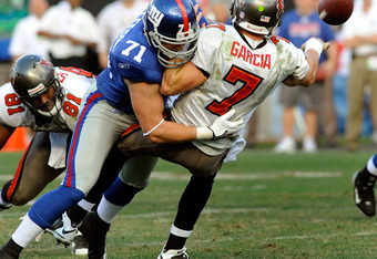 TAMPA, FL - JANUARY 06:  Defensive end Dave Tollefson #71 of the New York Giants sacks quarterback Jeff Garcia #7 of the Tampa Bay Buccaneers during the NFC Wild Card game at Raymond James Stadium on January 6, 2008 in Tampa, Florida.  The Giants won the game 24-14.  (Photo by Al Messerschmidt/Getty Images)