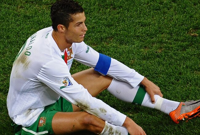 CAPE TOWN, SOUTH AFRICA - JUNE 29:  Dejected Cristiano Ronaldo of Portugal after his side is knocked out of the tournament during the 2010 FIFA World Cup South Africa Round of Sixteen match between Spain and Portugal at Green Point Stadium on June 29, 2010 in Cape Town, South Africa.  (Photo by Laurence Griffiths/Getty Images)