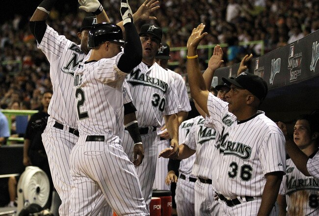 SAN JUAN, PUERTO RICO - JUNE 28:  Cody Ross #12 of the Florida Marlins is met by Manager Edwin Rodriguez and teammates after hitting a home run against The New York Mets during their game at Hiram Bithorn Stadium on June 28, 2010 in San Juan, Puerto Rico.  (Photo by Al Bello/Getty Images)