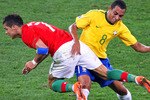 DURBAN, SOUTH AFRICA - JUNE 25:  Gilberto Silva of Brazil tackles Cristiano Ronaldo of Portugal during the 2010 FIFA World Cup South Africa Group G match between Portugal and Brazil at Durban Stadium on June 25, 2010 in Durban, South Africa.  (Photo by Steve Haag/Getty Images)