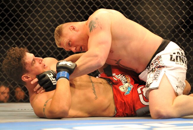 LAS VEGAS - JULY 11:  Brock Lesnar holds down Frank Mir during their heavyweight title bout during UFC 100 on July 11, 2009 in Las Vegas, Nevada.  (Photo by Jon Kopaloff/Getty Images)