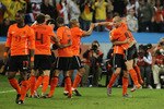 DURBAN, SOUTH AFRICA - JUNE 28:  John Heitinga of the Netherlands celebrates with Wesley Sneijder (R) and team mates after he scored the second goal during the 2010 FIFA World Cup South Africa Round of Sixteen match between Netherlands and Slovakia at Durban Stadium on June 28, 2010 in Durban, South Africa.  (Photo by Doug Pensinger/Getty Images)