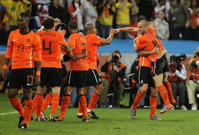 DURBAN, SOUTH AFRICA - JUNE 28:  John Heitinga of the Netherlands celebrates with Wesley Sneijder (R) and team mates after he scored the second goal during the 2010 FIFA World Cup South Africa Round of Sixteen match between Netherlands and Slovakia at Durban Stadium on June 28, 2010 in Durban, South Africa.  (Photo by Doug Pensinger/Getty Images)