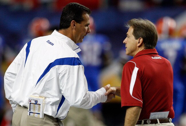 ATLANTA - DECEMBER 06:  Head coach Nick Saban of the Alabama Crimson Tide shakes hands with Urban Meyer, head coach of the Florida Gators before the start of the SEC Championship on December 6, 2008 at the Georgia Dome in Atlanta, Georgia.  (Photo by Chris Graythen/Getty Images)