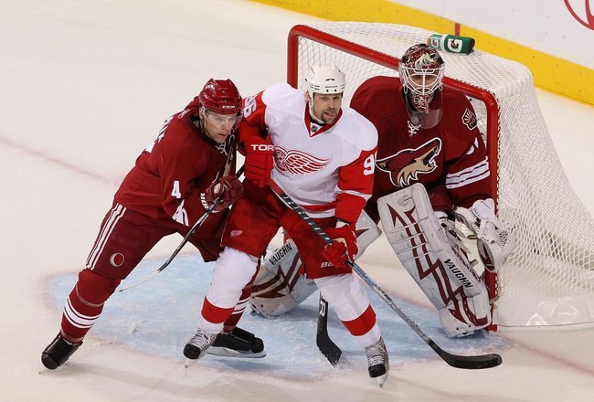 GLENDALE, AZ - APRIL 14:  Tomas Holmstrom #96 of the Detroit Red Wings attempts to set a screen on goaltender Ilya Bryzgalov #30 of the Phoenix Coyotes in Game One of the Western Conference Quarterfinals during the 2010 NHL Stanley Cup Playoffs at Jobing.com Arena on April 14, 2010 in Glendale, Arizona. The Coyotes defeated the Red Wings 3-2 to take a 1-0 series lead.  (Photo by Christian Petersen/Getty Images)