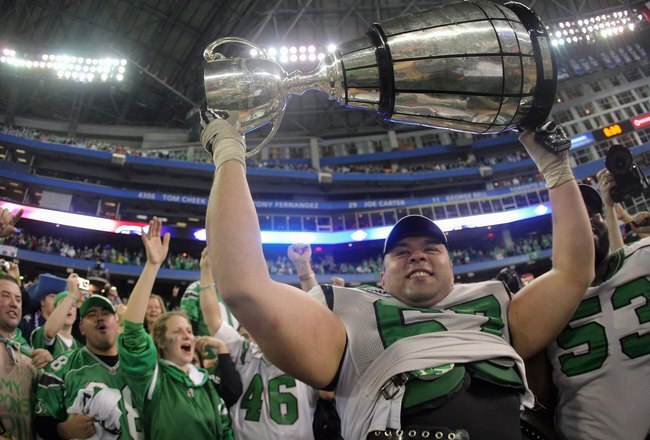 TORONTO - NOVEMBER 25:  Mike Abou-Mechrek #67 of the Saskatchewan Rough Riders hoists the Grey Cup in celebration of a 23-19 victory over the Winnipeg Blue Bombers during the 95th Grey Cup on November 25, 2007 at the Rogers Centre in Toronto, Ontario, Canada.  (Photo by Harry How/Getty Images)