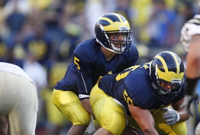 ANN ARBOR, MI - SEPTEMBER 5:  Tate Forcier #5 of the Michigan Wolverines stands under center David Molk #50 during the game against the Western Michigan Broncos on September 5, 2009 at Michigan Stadium in Ann Arbor, Michigan. (Photo by Gregory Shamus/Getty Images)