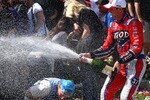 LONG BEACH - APRIL 18:  Ryan Hunter-Reay of the USA, driver of the #37 Team Izod Andretti Autosport Dallara Honda, celebrates his victory by spraying fans with champagne during the IndyCar Series Toyota Grand Prix of Long Beach on April 18, 2010 in Long Beach, California. (Photo by Donald Miralle/Getty Images)