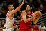 CHICAGO - MARCH 22: Luis Scola #4 of the Houston Rockets looks to pass under pressure from Brad Miller #52 of the Chicago Bulls at the United Center on March 22, 2010 in Chicago, Illinois. The Bulls defeated the Rockets 98-88. NOTE TO USER: User expressly acknowledges and agrees that, by downloading and/or using this Photograph, User is consenting to the terms and conditions of the Getty Images License Agreement. (Photo by Jonathan Daniel/Getty Images)