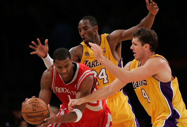 LOS ANGELES, CA - OCTOBER 30:  Tracy McGrady #1 of the Houston Rockets handles the ball under pressure from Kobe Bryant #24 and Luke Walton #4 of the Los Angeles Lakers during a game at Staples Center on October 30, 2007 in Los Angeles, California. NOTE TO USER: User expressly acknowledges and agrees that, by downloading and or using this Photograph, user is consenting to the terms and conditions of the Getty Images License Agreement.  (Photo by Jeff Gross/Getty Images)