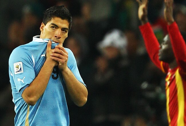 JOHANNESBURG, SOUTH AFRICA - JULY 02:  Luis Suarez of Uruguay walks off after being shown the red card for deliberate hand ball on the goal line during the 2010 FIFA World Cup South Africa Quarter Final match between Uruguay and Ghana at the Soccer City stadium on July 2, 2010 in Johannesburg, South Africa.  (Photo by Michael Steele/Getty Images)