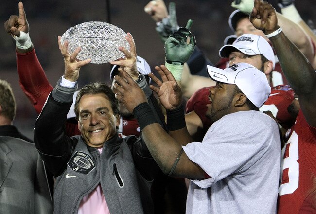 PASADENA, CA - JANUARY 07:  Head coach Nick Saban and running back Mark Ingram #22 of the Alabama Crimson Tide celebrate with the BCS Championship trophy after winning the Citi BCS National Championship game over the Texas Longhorns at the Rose Bowl on January 7, 2010 in Pasadena, California. The Crimson Tide defeated the Longhorns 37-21.  (Photo by Stephen Dunn/Getty Images)
