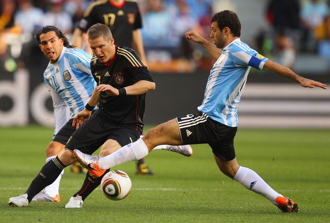 CAPE TOWN, SOUTH AFRICA - JULY 03:  Javier Mascherano of Argentina tackles Bastian Schweinsteiger of Germany during the 2010 FIFA World Cup South Africa Quarter Final match between Argentina and Germany at Green Point Stadium on July 3, 2010 in Cape Town, South Africa.  (Photo by Cameron Spencer/Getty Images)