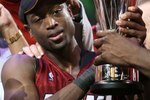 DALLAS - JUNE 20:  Dwyane Wade #3 of the Miami Heat holds up the MVP trophy after the Heat defeated the Dallas Mavericks in game six of the 2006 NBA Finals on June 20, 2006 at American Airlines Center in Dallas, Texas.  The Heat won 95-92 and win the series 4-2.  NOTE TO USER: User expressly acknowledges and agrees that, by downloading and or using this photograph, User is consenting to the terms and conditions of the Getty Images License Agreement.  (Photo by Ronald Martinez/Getty Images)