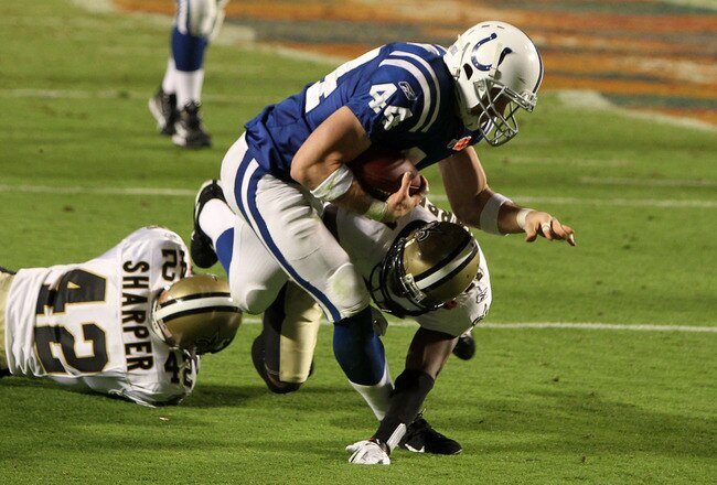 MIAMI GARDENS, FL - FEBRUARY 07:  Dallas Clark #44 of the Indianapolis Colts runs with the ball against Roman Harper #41 and Scott Shanle #58 of the New Orleans Saints during Super Bowl XLIV on February 7, 2010 at Sun Life Stadium in Miami Gardens, Florida.  (Photo by Ezra Shaw/Getty Images)