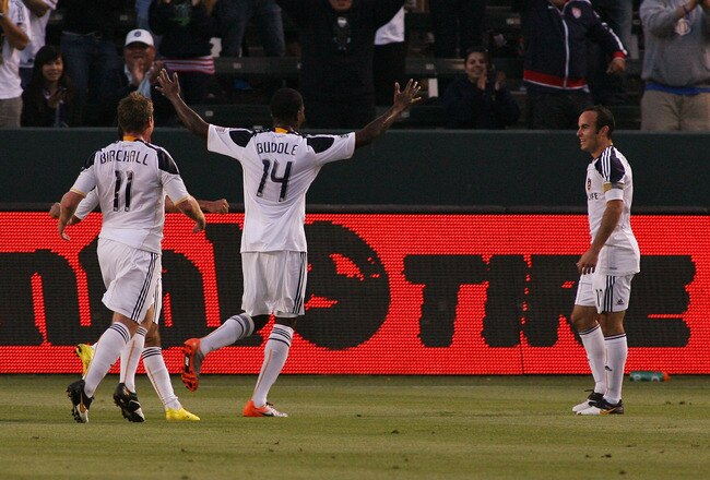 CARSON, CA - JULY 04:  Landon Donovan #10 of the Los Angeles Galaxy smiles as he waits to greet teammate Edson Buddle #14 after assisting on Buddle's goal against the Seattle Sounders FC on July 4, 2010 at the Home Depot Center in Carson, California.  Buddle and Donovan are playing in their first MLS game since returning from the 2010 FIFA World Cup in South Africa.  (Photo by Jeff Golden/Getty Images)