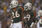 MIAMI - SEPTEMBER 21:  Defensive back Sean Taylor #26 and linebacker Darrell McClover #49 of the Miami Hurricanes stand on the field during the Big East Conference football game against the Boston College Eagles on September 21, 2002 at the Orange Bowl in Miami, Florida.  Miami won 38-6. (Photo by Andy Lyons/Getty Images)