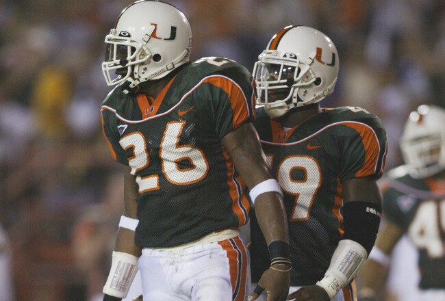 MIAMI - SEPTEMBER 21:  Defensive back Sean Taylor #26 and linebacker Darrell McClover #49 of the Miami Hurricanes stand on the field during the Big East Conference football game against the Boston College Eagles on September 21, 2002 at the Orange Bowl in Miami, Florida.  Miami won 38-6. (Photo by Andy Lyons/Getty Images)