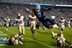 CHAPEL HILL, NC - OCTOBER 22:  Greg Little #8 of the North Carolina Tar Heels dives past Florida State Seminole defenders for a first quarter touchdown at Kenan Stadium on October 22, 2009 in Chapel Hill, North Carolina.  (Photo by Scott Halleran/Getty Images)