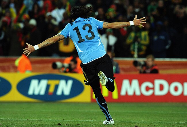 JOHANNESBURG, SOUTH AFRICA - JULY 02:  Sebastian Abreu of Uruguay celebrates scoring the winning penalty in the shoot out during the 2010 FIFA World Cup South Africa Quarter Final match between Uruguay and Ghana at the Soccer City stadium on July 2, 2010 in Johannesburg, South Africa.  (Photo by Stanley Chou/Getty Images)