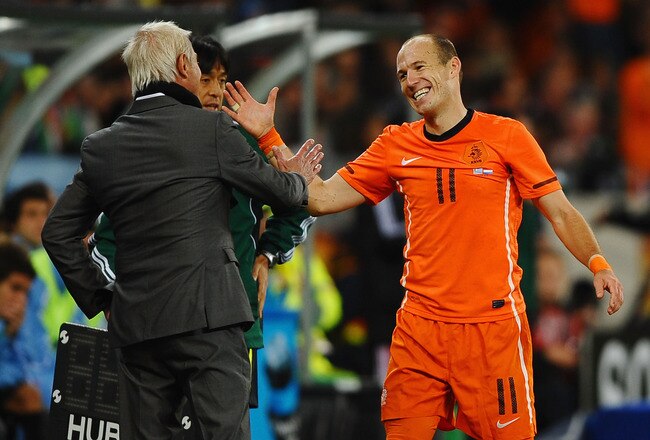 CAPE TOWN, SOUTH AFRICA - JULY 06:  Bert van Marwijk head coach of the Netherlands celebrates with Arjen Robben victory and progress to the final after the 2010 FIFA World Cup South Africa Semi Final match between Uruguay and the Netherlands at Green Point Stadium on July 6, 2010 in Cape Town, South Africa.  (Photo by Laurence Griffiths/Getty Images)