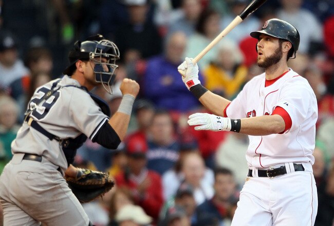 BOSTON - MAY 08:  Jeremy Hermida #32 of the Boston Red Sox reacts after striking out to end the sixth inning as Francisco Cervelli #29 of the New York Yankees celebrates on May 8, 2010 at Fenway Park in Boston, Massachusetts.  (Photo by Elsa/Getty Images)