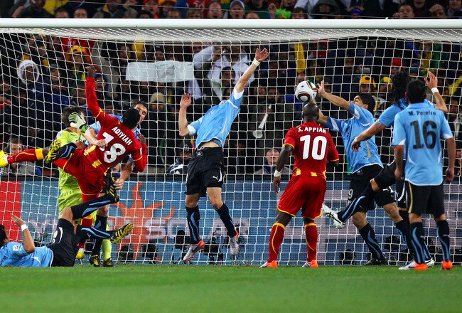 JOHANNESBURG, SOUTH AFRICA - JULY 02:  Luis Suarez of Uruguay handles the ball on the goal line, for which he is sent off, during the 2010 FIFA World Cup South Africa Quarter Final match between Uruguay and Ghana at the Soccer City stadium on July 2, 2010 in Johannesburg, South Africa.  (Photo by Michael Steele/Getty Images)