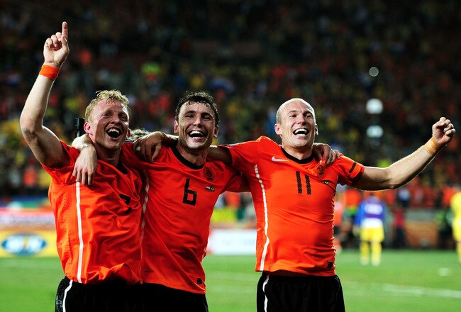 PORT ELIZABETH, SOUTH AFRICA - JULY 02:  Mark Van Bommel (C) of the Netherlands celebrates victory with Dirk Kuyt and Arjen Robben following the 2010 FIFA World Cup South Africa Quarter Final match between Netherlands and Brazil at Nelson Mandela Bay Stadium on July 2, 2010 in Nelson Mandela Bay/Port Elizabeth, South Africa.  (Photo by Laurence Griffiths/Getty Images)