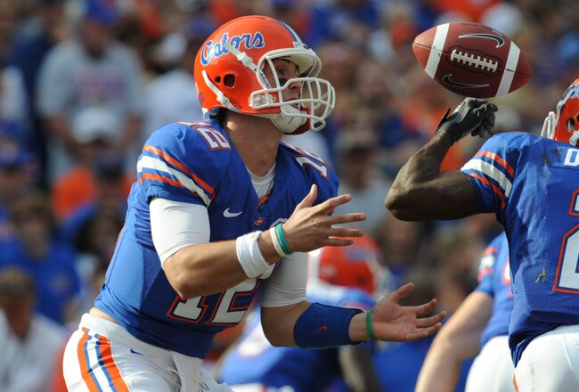 GAINESVILLE, FL - NOVEMBER 21: Quarterback John Brantley #12 of the Florida Gators bobbles a snap from center against the Florida International University Golden Panthers, November 21, 2009 at Ben Hill Griffin Stadium in Gainesville, Florida.  (Photo by Al Messerschmidt/Getty Images)