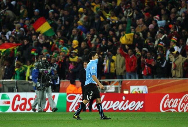 JOHANNESBURG, SOUTH AFRICA - JULY 02:  Luis Suarez of Uruguay is sent off after handling the ball on the goal line during the 2010 FIFA World Cup South Africa Quarter Final match between Uruguay and Ghana at the Soccer City stadium on July 2, 2010 in Johannesburg, South Africa.  (Photo by Clive Rose/Getty Images)